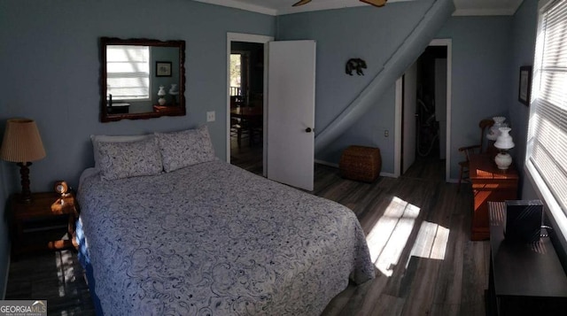 bedroom featuring crown molding and wood finished floors