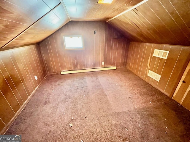 bonus room featuring lofted ceiling, wood walls, and baseboard heating