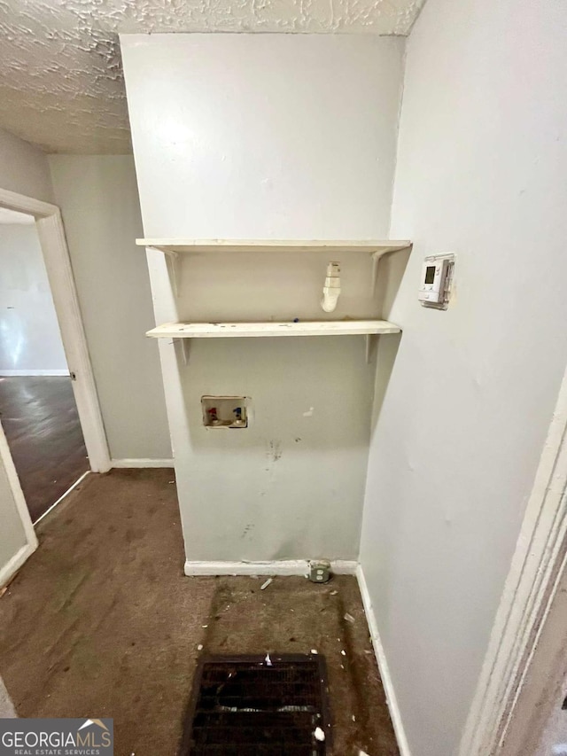 clothes washing area with laundry area, washer hookup, and baseboards