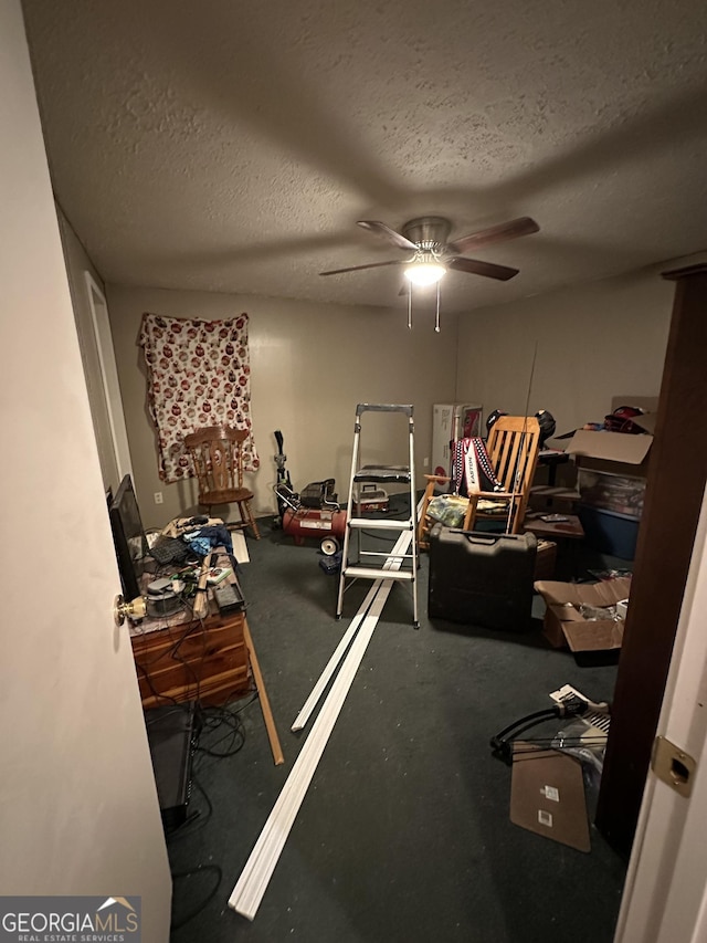 interior space featuring ceiling fan and a textured ceiling