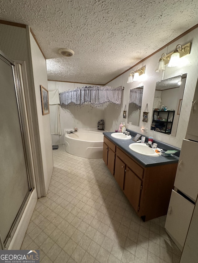 bathroom featuring a bath, crown molding, a sink, and tile patterned floors