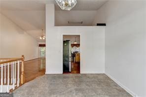 unfurnished room featuring lofted ceiling