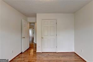 unfurnished bedroom with baseboards and wood finished floors