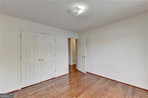 unfurnished bedroom featuring a closet and wood finished floors