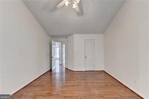 spare room featuring a ceiling fan and wood finished floors