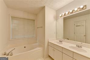 bathroom with double vanity, a tub to relax in, and a sink