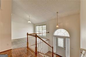 interior space with vaulted ceiling and wood finished floors