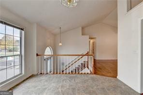 spare room with lofted ceiling