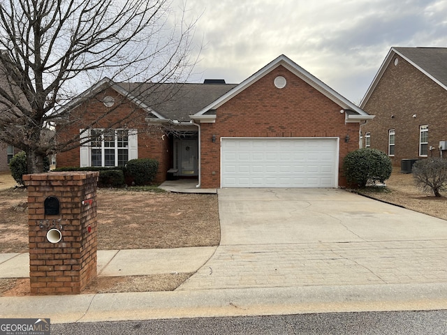 view of front of home with driveway, brick siding, an attached garage, and cooling unit