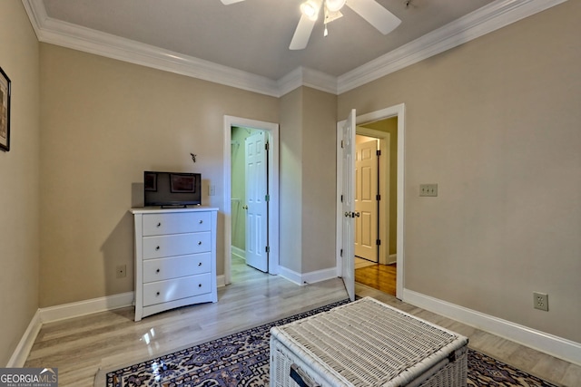 bedroom featuring baseboards, ornamental molding, and light wood-style floors