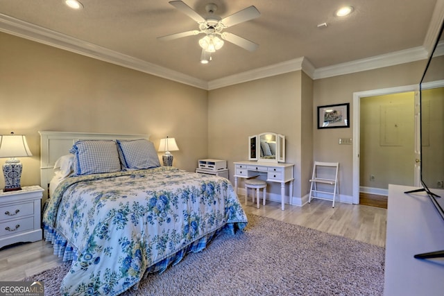 bedroom featuring ornamental molding, baseboards, and wood finished floors