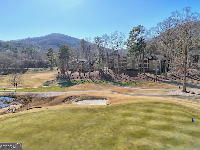 surrounding community featuring a lawn and a mountain view