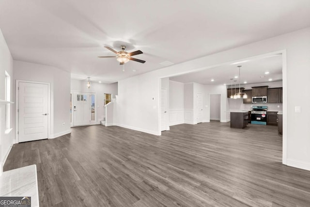 unfurnished living room featuring a ceiling fan, recessed lighting, dark wood-style flooring, and baseboards