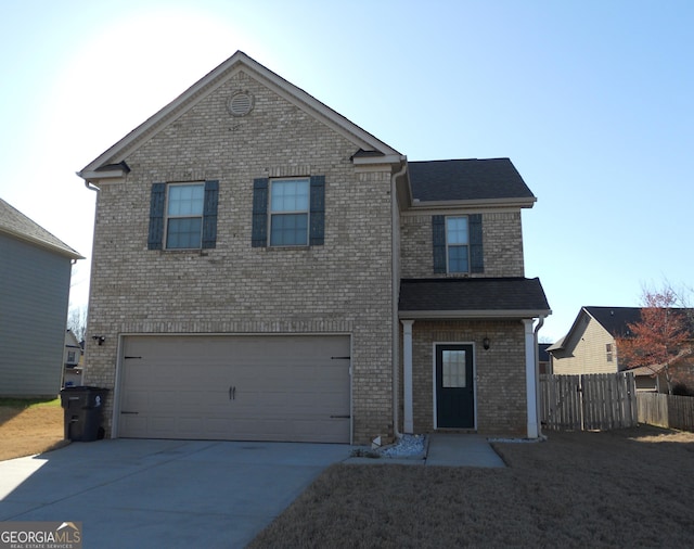 traditional home featuring a garage, concrete driveway, and brick siding