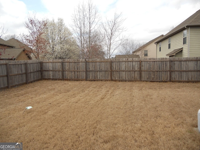 view of yard with a fenced backyard