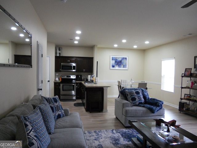 living area with baseboards, recessed lighting, visible vents, and light wood-style floors