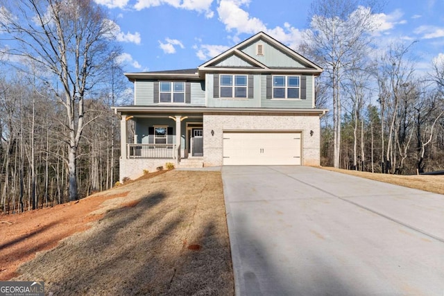 view of front facade featuring covered porch, driveway, brick siding, and an attached garage