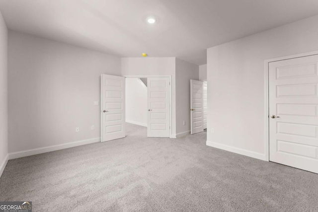 unfurnished bedroom with carpet, baseboards, and recessed lighting