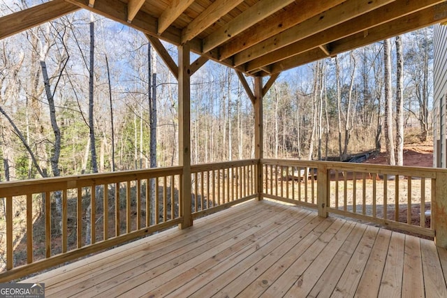 wooden deck with a view of trees