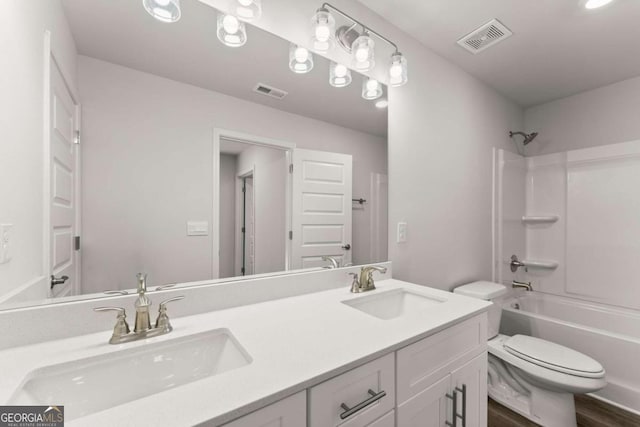 bathroom with  shower combination, visible vents, a sink, and toilet