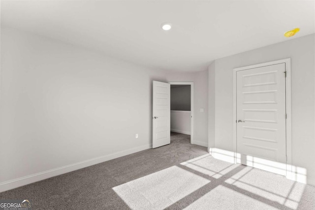 unfurnished bedroom featuring carpet floors and baseboards