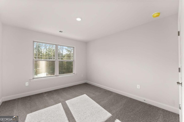 carpeted spare room with recessed lighting and baseboards