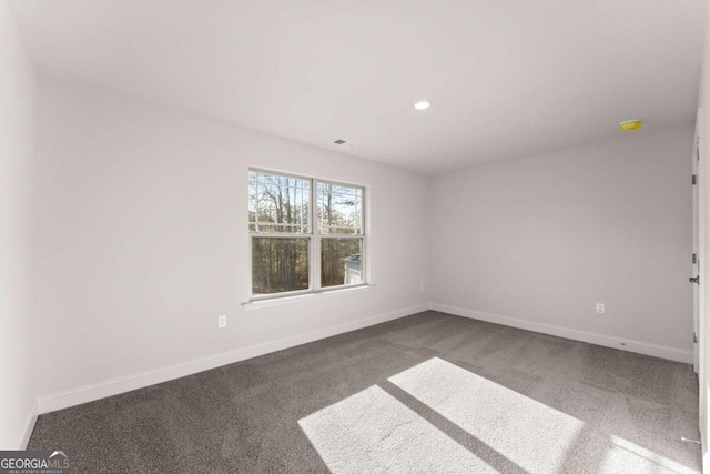 empty room featuring recessed lighting, carpet, visible vents, and baseboards