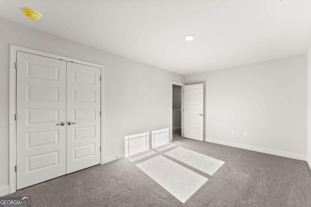 unfurnished bedroom with carpet and baseboards