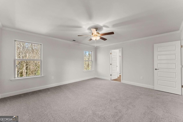 unfurnished room featuring visible vents, ornamental molding, carpet flooring, ceiling fan, and baseboards