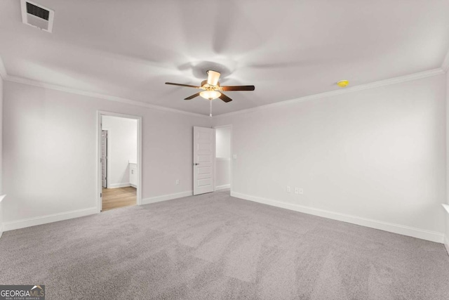 unfurnished bedroom featuring carpet floors, a ceiling fan, baseboards, visible vents, and crown molding