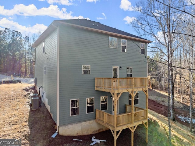 rear view of property with central AC and a wooden deck