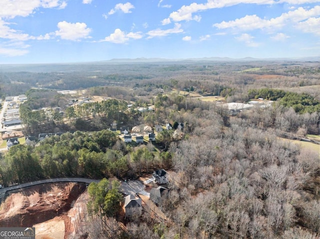 birds eye view of property featuring a view of trees