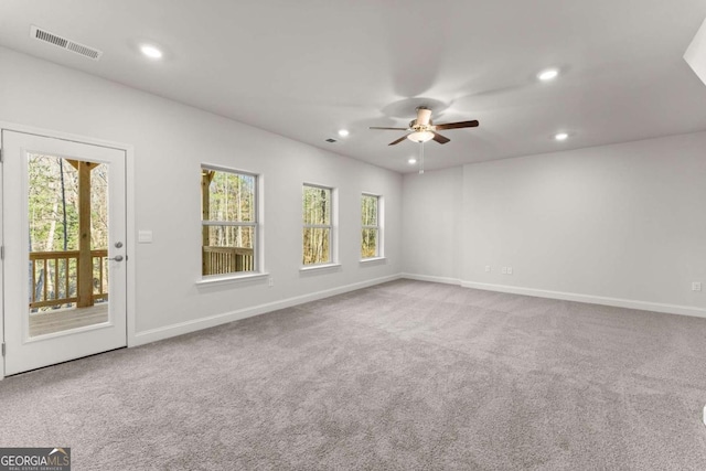 carpeted spare room with baseboards, visible vents, and recessed lighting