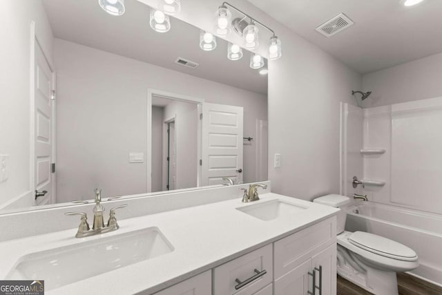 bathroom featuring toilet, shower / bathtub combination, a sink, and visible vents