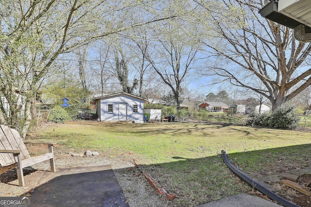 view of yard featuring fence and an outdoor structure