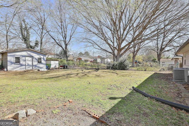 view of yard featuring an outbuilding and central air condition unit