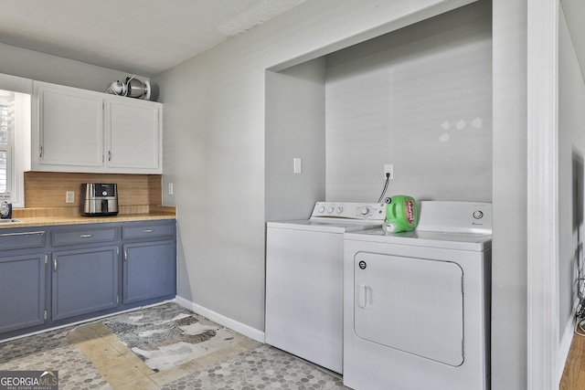 laundry area featuring baseboards and washer and dryer