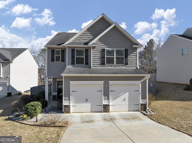 view of front of property with stone siding, concrete driveway, and an attached garage