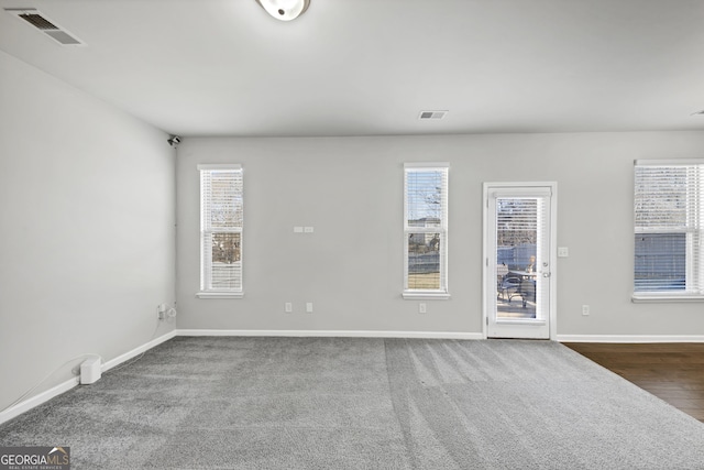 unfurnished room with visible vents and plenty of natural light