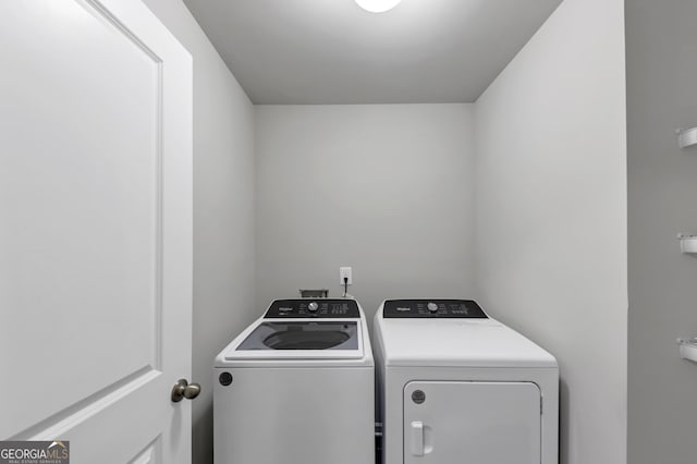 clothes washing area with laundry area and washing machine and clothes dryer