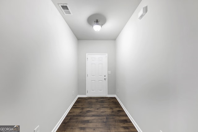 entryway with dark wood-type flooring, visible vents, and baseboards