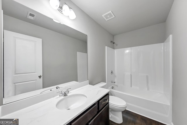 bathroom with toilet, shower / tub combination, visible vents, and wood finished floors