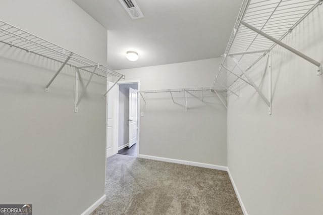 walk in closet featuring carpet flooring and visible vents