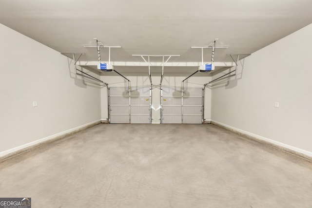 garage with baseboards and a garage door opener