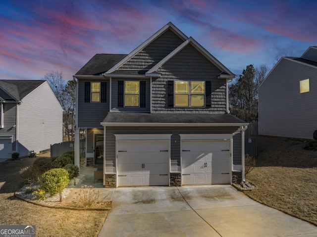 view of front of property with a garage, concrete driveway, and stone siding