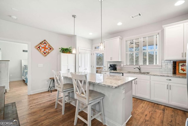 125 Grand Cir, Jasper, GA 30143 - kitchen featuring light wood finished floors, a breakfast bar area, white cabinetry, recessed lighting, and light stone countertops
