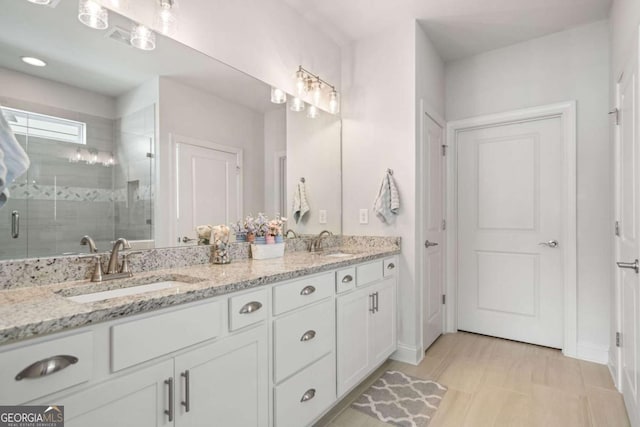 125 Grand Cir, Jasper, GA 30143 - bathroom with double vanity, a shower stall, and baseboards