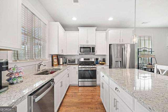 125 Grand Cir, Jasper, GA 30143 - kitchen with appliances with stainless steel finishes, a sink, white cabinetry, recessed lighting, and light stone counters