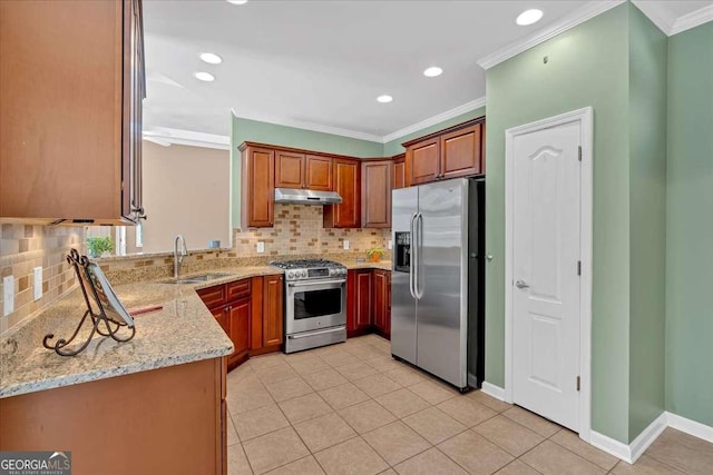 kitchen featuring under cabinet range hood, stainless steel appliances, a sink, light stone countertops, and crown molding