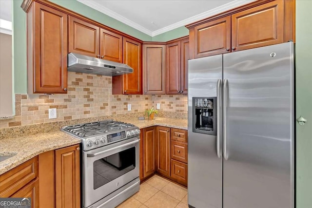 kitchen featuring light tile patterned flooring, under cabinet range hood, stainless steel appliances, decorative backsplash, and crown molding